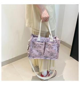 Close-up of pink tote bag with grey bamboo leaf pattern and dual front pockets