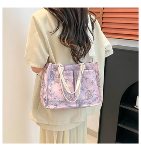 Close-up of lavender tote bag with bamboo leaf pattern and adjustable shoulder strap