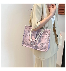 Detail of lavender tote bag with bamboo leaf print, featuring external pockets and wide strap