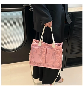 Detailed view of pink tote bag with bamboo leaf pattern and dual front pockets