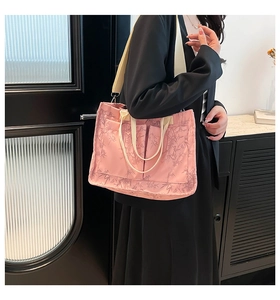 Pink tote bag with bamboo leaf pattern featuring adjustable strap and outer pockets