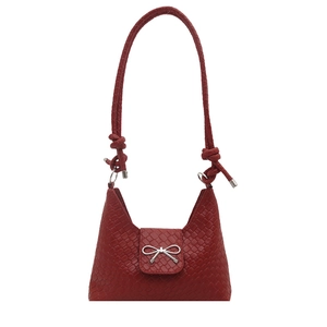 Red woven shoulder bag for women with elegant silver bow detail and knotted handle strap