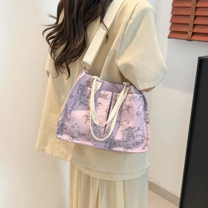Lavender tote bag with bamboo leaf pattern and shoulder strap shown on a model