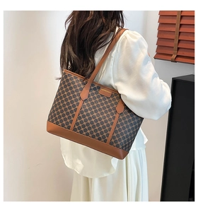 Detail view of large capacity vintage tote bag featuring classic monogram canvas patterns