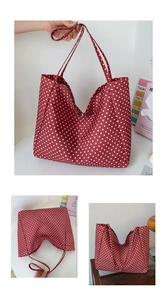 Detail of red canvas tote bag with white polka dots featuring large capacity and wide straps