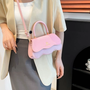 Pink and lilac color-block handbag with wavy flap and adjustable crossbody strap