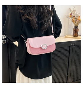 Detail of pink crossbody bag with dual-texture fabric and silver D-buckle closure