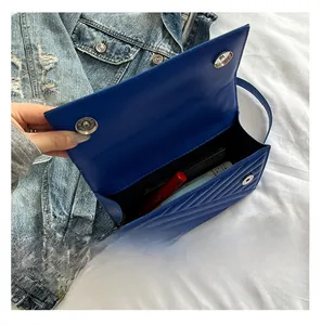 Detail view of the interior capacity of the blue quilted shoulder bag with metal closure