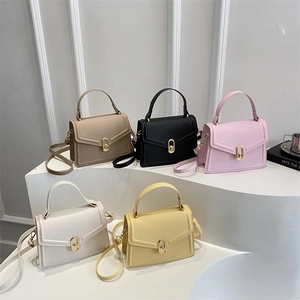 Minimalist leather crossbody handbags with gold oval locks in five colors on display
