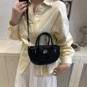 Chic black half-moon crossbody bag with silver buckle and sleek chain strap for women