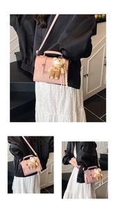 Pink crossbody bag with woven texture detail and cute plush bear charm decoration