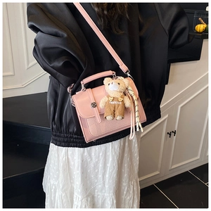 Pink crossbody bag with woven texture, fashion bear charm and adjustable strap