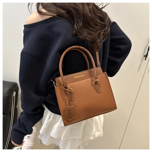 Brown lychee leather tote bag with top handles and gold FASHION & BAGS lettering detail