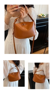 Detail of caramel leather handbag featuring a golden metal twist lock and smooth texture