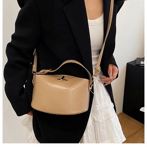 Detailaufnahme einer beigen minimalistischen Umhängetasche mit goldenem Verschluss aus PU