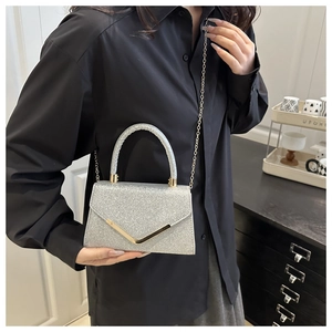 Silver glitter evening handbag with gold V-metal trim and chain strap detail