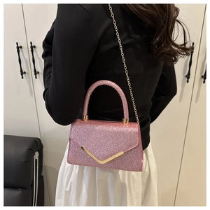 Detailed back view of pink sequin mini handbag with golden chain strap on model