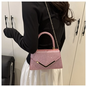 Detailed back view of pink glitter handbag with gold V-decoration and chain strap