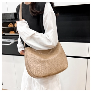 Detailed view of beige woven texture and spacious interior of the tote dumpling bag