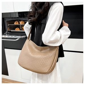 Detail of hobo shoulder bag with tight woven texture in khaki brown finish