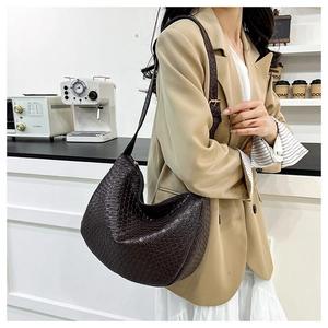 Close-up of dark brown woven PU leather hobo bag with detailed braided texture
