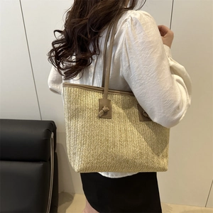 Minimalist beige woven tote bag with brown faux leather handles for summer fashion