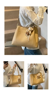 Detail of coffee brown large tote bag with lychee texture and cute bear charm