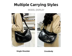 Detail of black patent leather dumpling bag showing adjustable wide shoulder strap styles