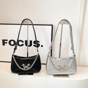Chic crescent shoulder bags in black and silver with butterfly charms and metal chains