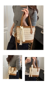 Detail of woven straw bucket bag with brown leather base and delicate white lace ribbon