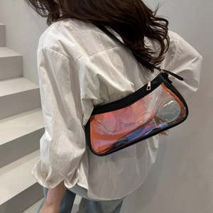 Iridescent clear PVC underarm bag with black trim worn by a model on white stairs