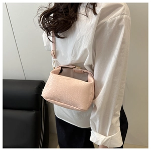 Detail of light pink faux snake skin crossbody bag with adjustable shoulder strap