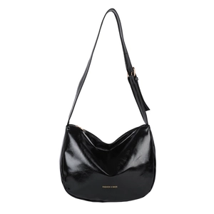 Glossy black crescent shoulder bag with gold hardware and adjustable strap on white background