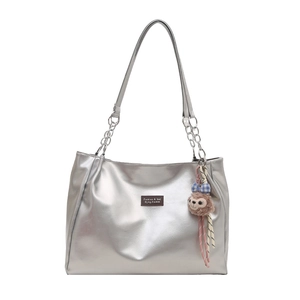 Large silver tote bag with metallic finish, chain straps and cute bear charm decoration