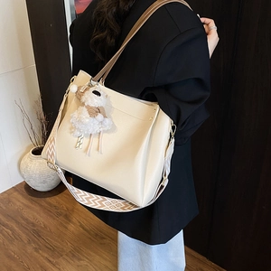 Large beige tote bag with a patterned wide strap and plush sheep charm for summer commuting