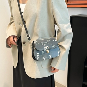 Minimalist square crossbody bag in grey-blue with white floral vine print and golden buckle
