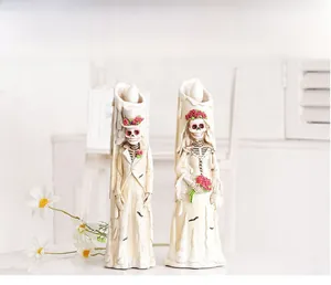 Detailed close-up of Halloween resin skeleton bride and groom candle lights for bar decor
