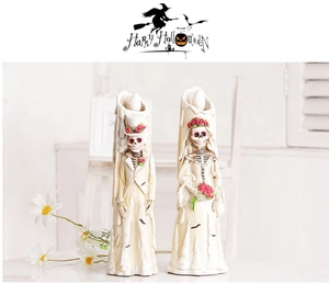Detail of Halloween skeleton bride and groom figurines with melting candle texture