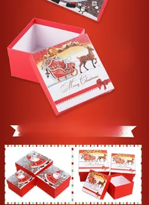 Macro view of square red Christmas gift box with Santa Claus and reindeer illustrations