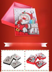 Detail of Christmas gift boxes with Santa and reindeer designs and glitter finish
