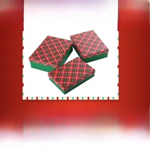 Three square Christmas gift boxes with red plaid lids and dark green bases set