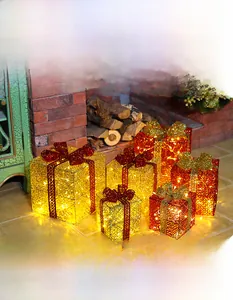 Macro detail of glowing iron art gift box with warm LED light and shiny red bow