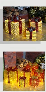 Detail of glowing Christmas gift boxes with warm LED lights and festive plaid bows