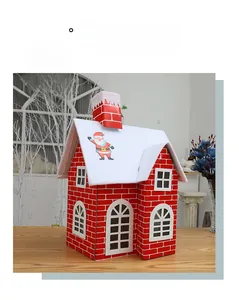 Close-up of a festive red snow house ornament on a rustic wood surface for Christmas decor