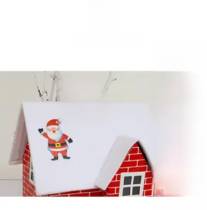 Detailed view of festive red brick Christmas house decoration with snowy roof and Santa figure