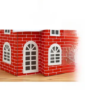 Detail of a Christmas decorative house with red brick print and snow-covered roof