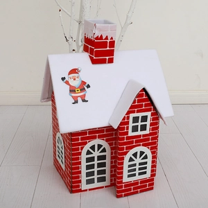 Red brick Christmas house decoration box with snowy roof and Santa Claus chimney