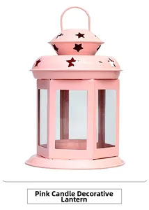 Pink vintage metal candle lantern with star-shaped cutouts and clear glass panels