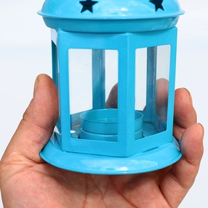 Sky blue hexagonal metal lantern with star cutouts and glass panels for home decor