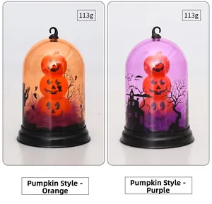 Detail view of orange and purple Halloween pumpkin lantern domes with spooky silhouettes